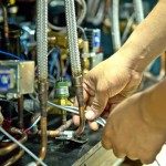 a person is working on a machine with a wrench .