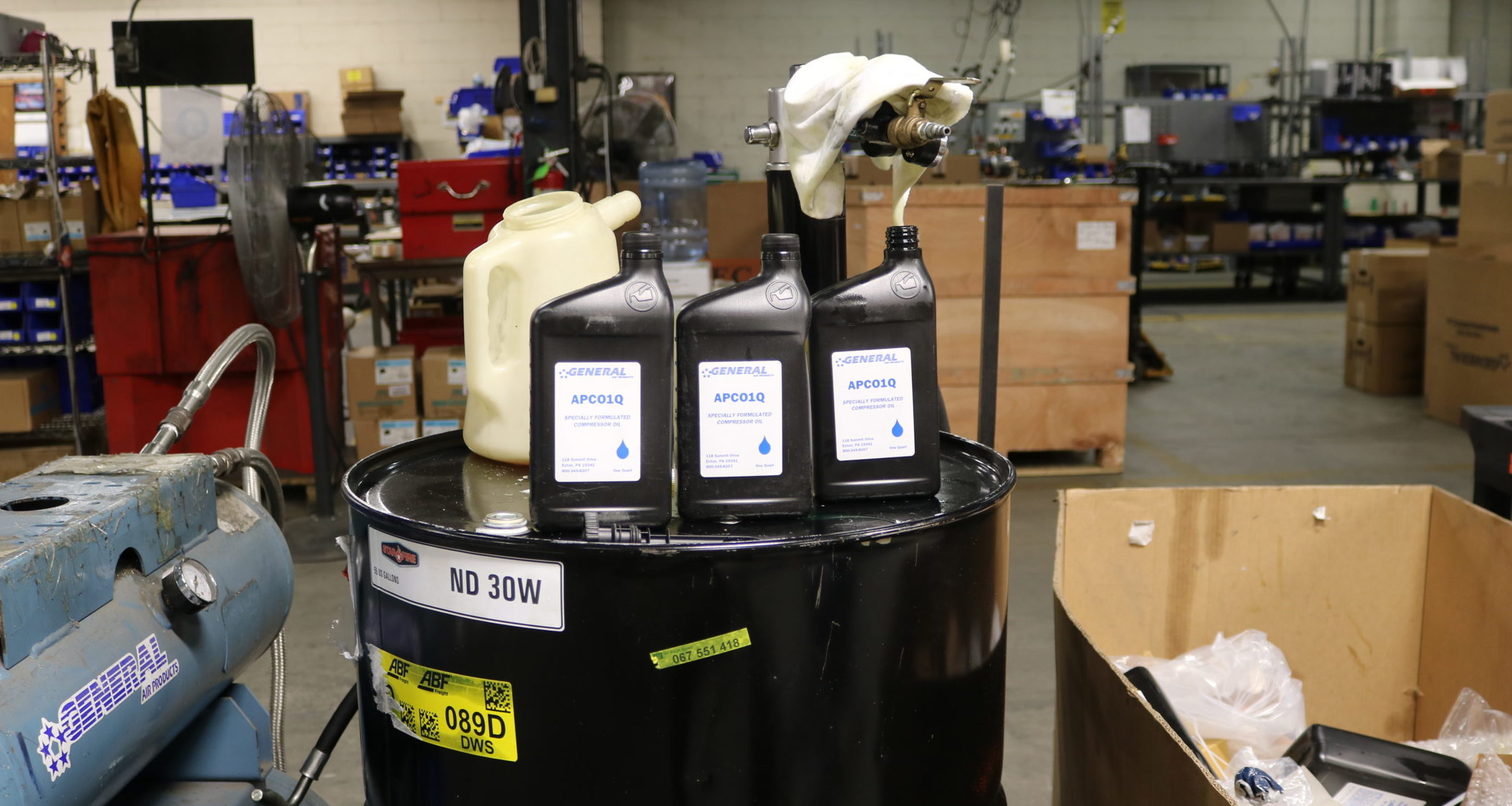 three bottles of apcoo2 sit on top of a black barrel