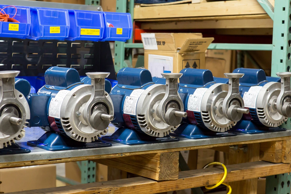 a row of blue and silver pumps are lined up on a shelf