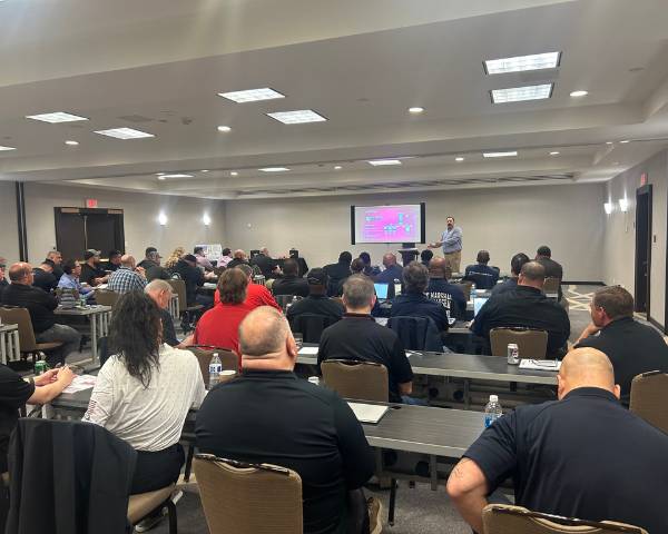A crowed room recieving a presentation